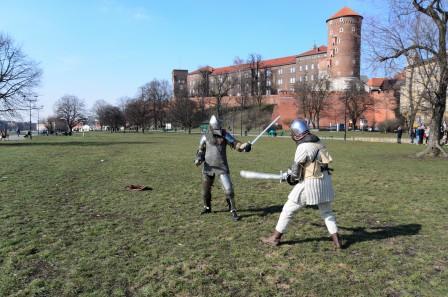 two knights swinging swords in front of Wawel Castle Krakow