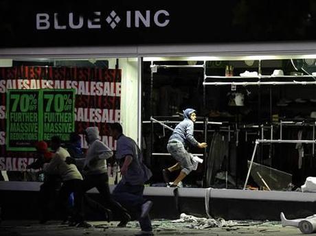 Image: Looters run from a clothing store in Peckham, south London