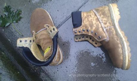 Photo - two boots, with no laces, lying on a street in Edinburgh