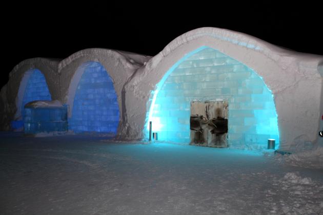 ICEHOTEL Sweden by night.  The darker blue arches on the left are UNIQUE ICEBAR