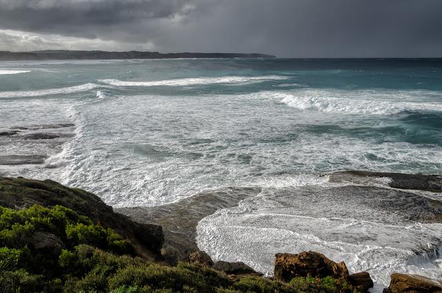 waves and dark clouds over nelson bay