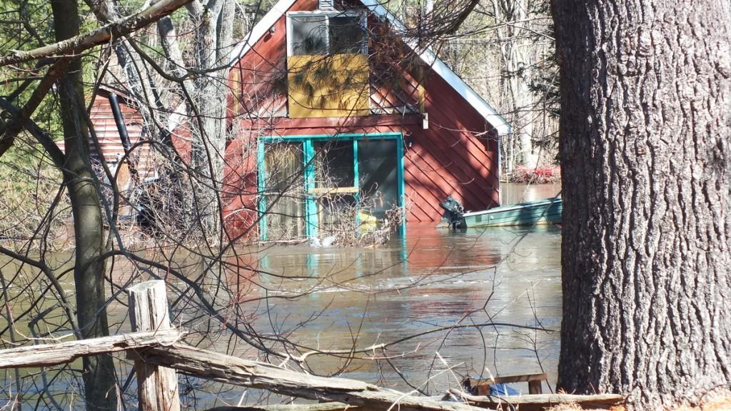 Big East River flood zone - flooded red colored home - Huntsville, Ontario - April 21 2013