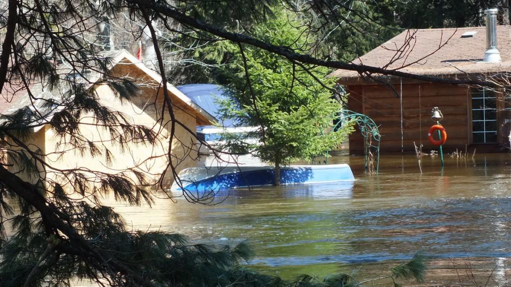 Big East River flood zone - a boat not a float - Huntsville, Ontario - April 21 2013