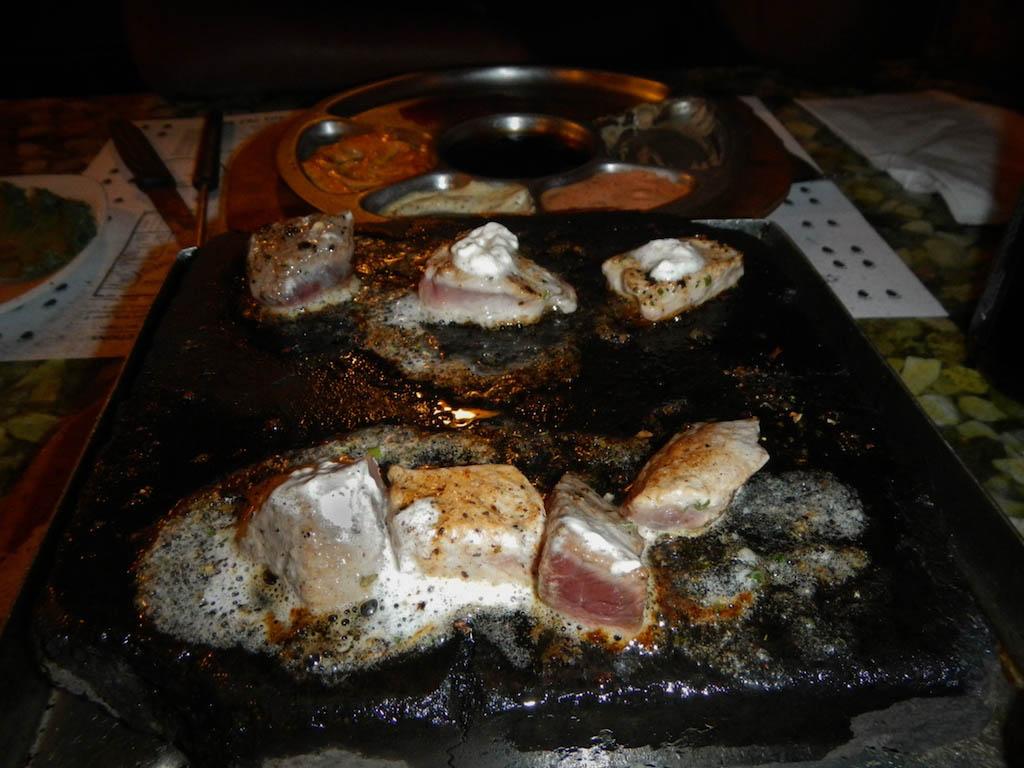 Fondue meat drizzled with garlic herb butter. 