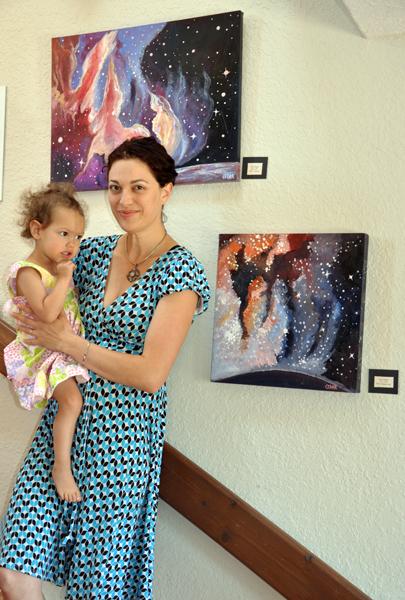 Cedar Lee Artist with her daughter and paintings: Top: New World. ©  Cedar Lee 2013 Bottom: Star Clouds. © Cedar Lee 2013