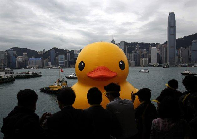 Students watch as Rubber Duck by Dutch artist Hofman floats near Ocean Terminal at Hong Kong's Victoria Harbour