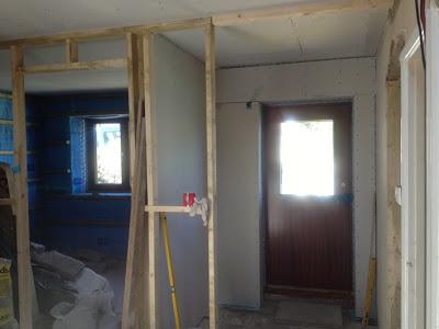 Plasterboard fitted to walls by front door