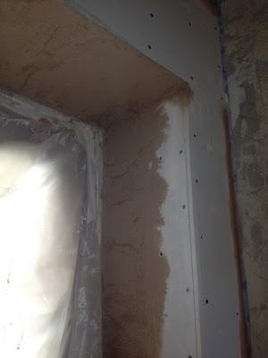 First cost of bonding plaster to even up levels over brickwork next to doorframe.