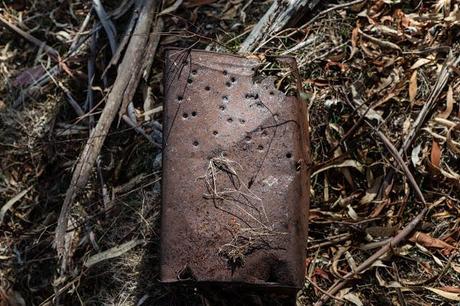 old tin can with bullet holes