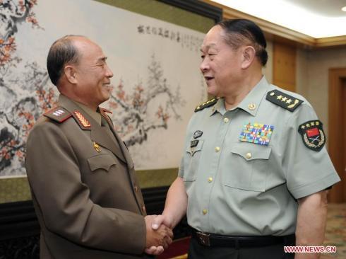 Col. Gen. Jon Chang Bok (L) shakes hands with former Chinese Defense Minister Liang Guanglie (R) in Beijing on 26 August 2011.  At the time Col. Jon was leading a KPA logistics delegation on a visit to China.  Jon was appointed 1st Vice Minister of the People's Armed Forces in May 2013. (Photo: Xinhua/Xie Huanchi)