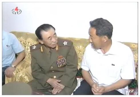 VMar Hyon Chol Hae talks with a Changjon Street resident while visiting the man's apartment on 6 July 2012 (Photo: KCNA/KCTV still)