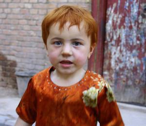 A very White looking, in fact, red-haired, Uighur child, who could easily be an Irish kid.