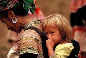 A Hmong woman with, incredibly enough, a blond baby. When I worked with the Hmong, they told me that blond and blue eyed babies were sometimes born to Hmong women, a legacy of their origin in the Tarim Basin long ago.