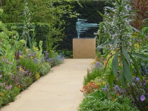 garden statue at end of flower borders