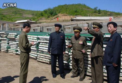 DPRK Premier Pak Pong Ju (1) is briefed about the construction of KPA Breeding Station #621, a facility which will breed grass-fed livestock.  Also in attendance is DPRK Vice Premier and State Planning Commission Chairman Ro Tu Chol (2) (Photo: KCNA).