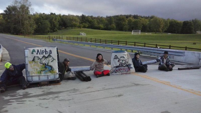 5 people locked to tank of dirty 250 gal of water and a barrel blocking entrance to Alpha Natural Resources' HQ.