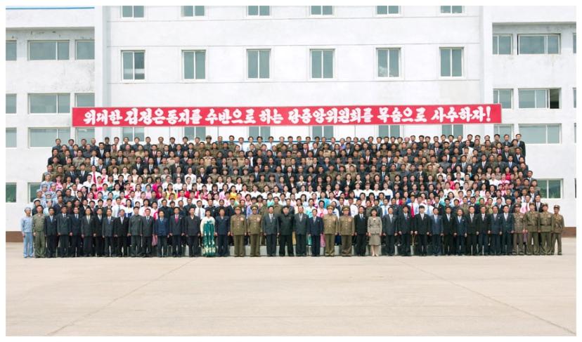 Kim Jong Un poses for a commemorative photograph after touring a foodstuffs factory under KPA Unit 534 (Photo: Rodong Sinmun).