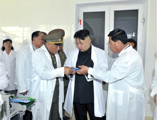 Kim Jong Un (1) learns about a product during a visit to the foodstuffs factory under KPA Unit #634 (Photo: Rodong Sinmun).