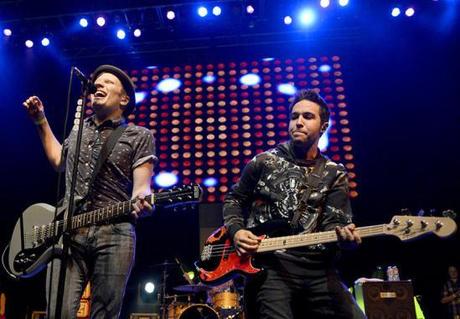 Patrick Stump, left, and Pete Wentz command the stage during Fall Out Boy’s special 1 a.m. set at Austin’s Vice Bar during SXSW March 16, 2013. [Image from http://s3.amazonaws.com]