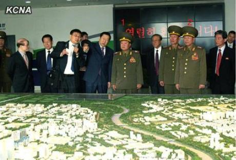 VMar Choe Ryong Hae (1), special envoy of Kim Jong Un, views a scale model of Beijing Economic and Technological Development Park.  Also in attendance is Col. Gen. Gen. Ri Yong Gil (2), chief of the KPA General Staff Operations Bureau (Photo: KCNA).