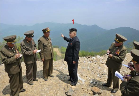 Kim Jong Un (1) talks with senior officials and KPA construction managers on a peak at the construction site of the Masik Pass Ski Park in Kangwo'n Province (Photo: Rodong Sinmun).