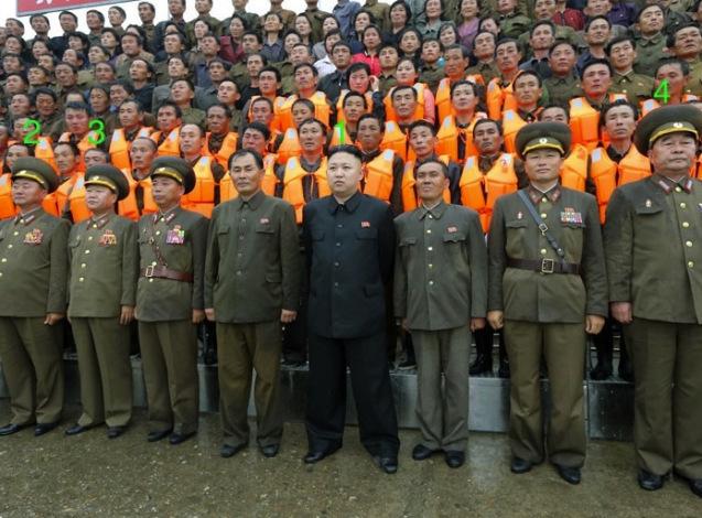 Kim Jong Un (1) poses for a commemorative photograph with managers and employees of the 25 August Fishery Station of KPA Unit #313.  Also seen in attendance is Minister of the People's Armed Forces Gen. Jang Jong Nam (2), Director of the KPA General Political Department VMar Choe Ryong Hae (3) and Chief of the KPA General Staff Gen. Kim Kyok Sik (4) (Photo: Rodong Sinmun).