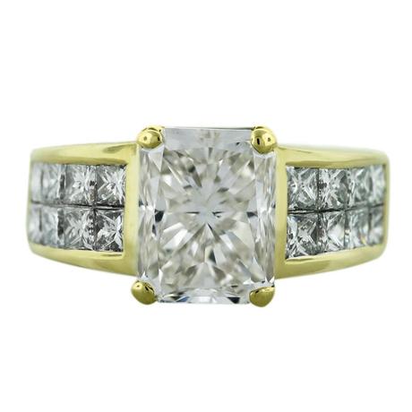 Radiant cut diamond engagement ring set in 18kt yellow gold with invisibly set princess cuts