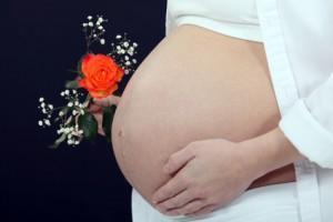 Pregnant woman holding flower