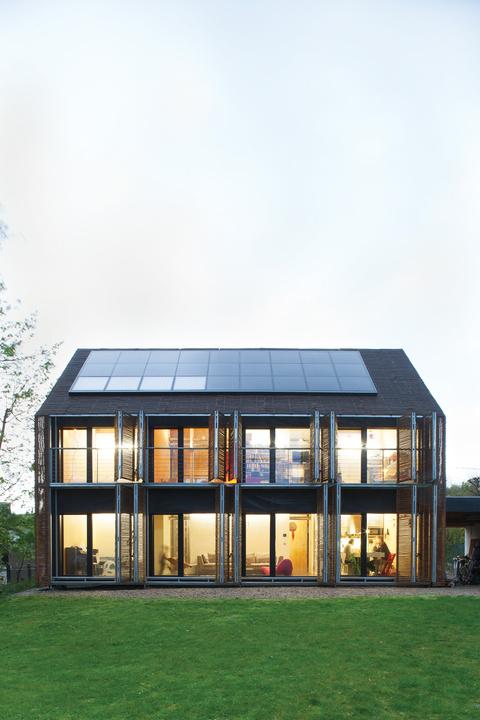 Modern bamboo-clad farmhouse with solar panels 