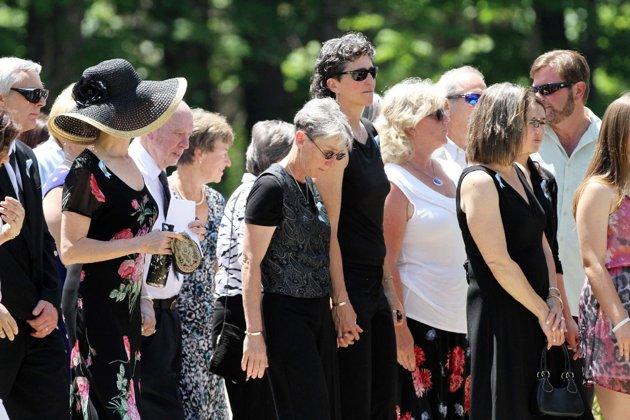 Family and friends arrive for a memorial service for Nancy Lanza on Saturday June 1, 2013 in Kingston, N.H. Lanza’s 20-year-old son, Adam Lanza, killed her at their home in Newtown, Conn., on Dec. 14 and then drove to Sandy Hook Elementary School, where he killed the children and six school employees before committing suicide. (AP Photo/Jim Cole)