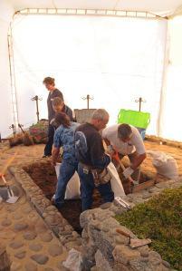 In this photo released by Chile's Judiciary, forensic specialists dig at the grave of Nobel laureate Pablo Neruda as they prepare for the exhumation of the remains in Isla Negra, Chile, Sunday April 7, 2013. (AP Photo / Judiciary of Chile)