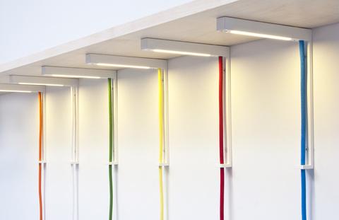Lightbracket lamp from AlexAllen Studio supports a shelf like a bracket and illuminates the space underneath. 