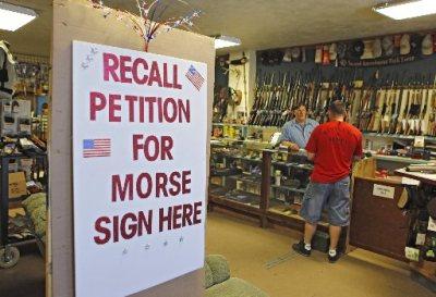 In this photo taken May 24, 2013, a large sign posted at the entrance of Paradise Firearms in Colorado Springs, Colo., invites customers to sign a recall petition against Colorado Democratic State Senate President John Morse.(Phot by: Ed Andrieski/AP Photo)