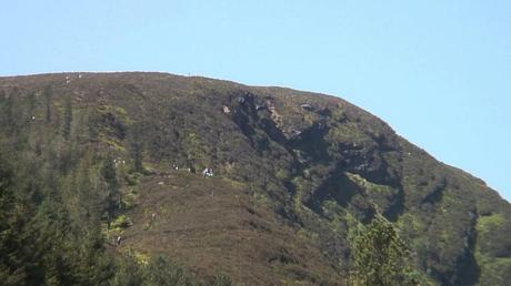 people climb up to prezen rock - wicklow mountains national park - ireland