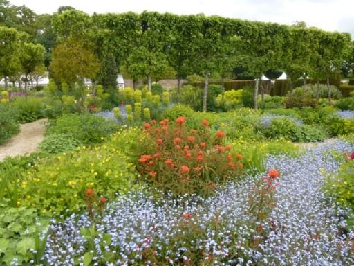 verdant green borders punctuated by vibrant flowers