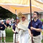 Msgr. Joseph Prior, pastor of St. John the Evangelist, carries the eucharist for the the final blocks of the procession.