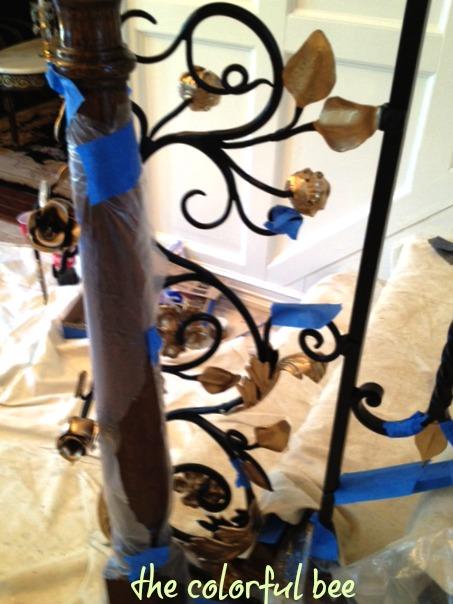 starting to apply the gold to the wrought iron railing