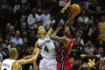 Watch out LeBron!: Danny Green gets a hand on LeBron James' layup, a key play that led the Spurs trouncing all over the Heat.