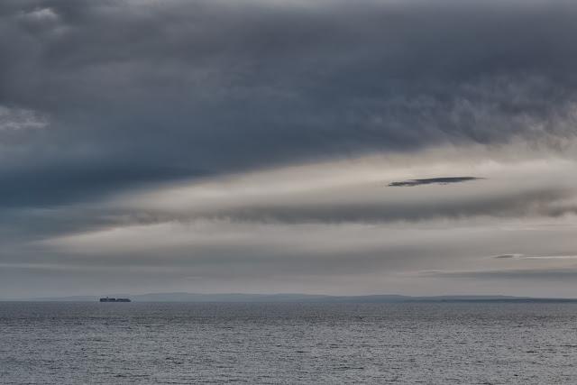 ship at sea under dark clouds