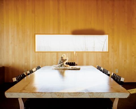 Modern dining room with wooden table and walls