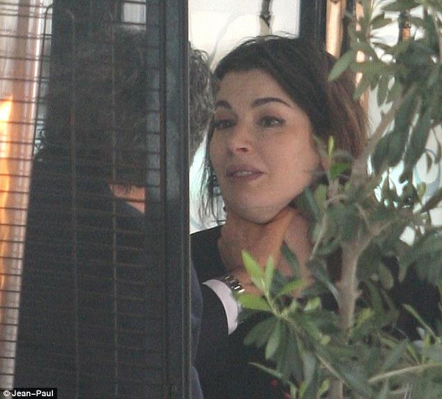 Shocking pictures: Sitting in their favorite Mayfair restaurant, Charles Saatchi repeatedly grabs his wife Nigella Lawson by the neck