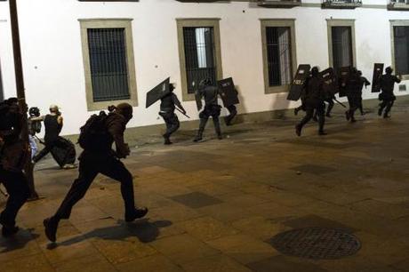 Chased by demonstrators, police officers retreat during a protest near the state legislative assembly in Rio de Janeiro, on June 17, 2013. (AP Photo/Felipe Dana) See more photos here