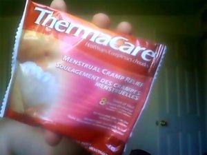 Close up of a ThermaCare HeatWrap for menstrual pain in its pouch.