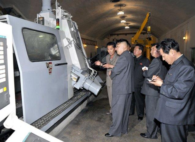 Kim Jong Un is briefed about a machine at Kanggye General Tractor Plant (Photo: Rodong Sinmun).