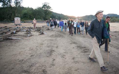 Crowd of supporters marches onto wetlands destruction site to resupply Red-Tailed Hawk, who has run out of food.