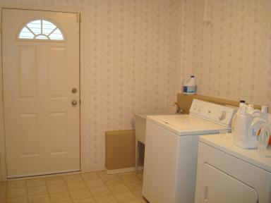 Laundry room - That wallpaper is GOING!