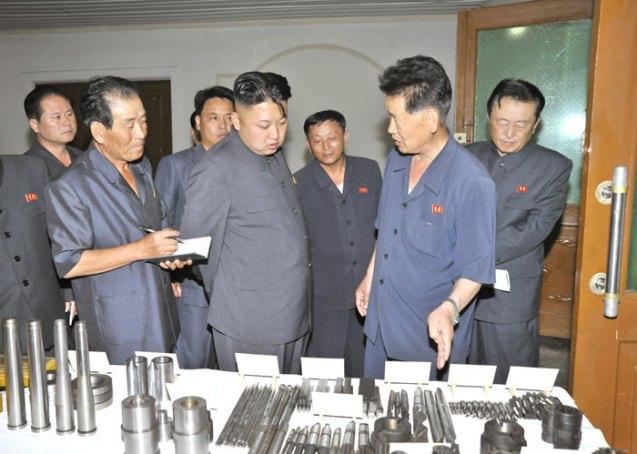 Kim Jong Un (2nd L) is briefed about some of the products of Jangjagang Machine Tools Plant in Kanggye, Chagang Province (Photo: Rodong Sinmun).