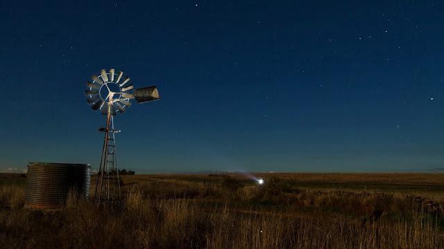shining a torch on a windmill at night