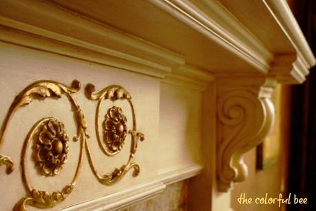 gilded and antiqued mantle and onlays on a fireplace mantle