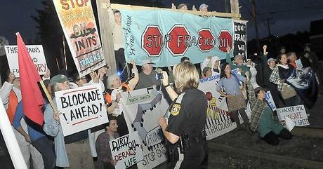 Members from 350 Maine, who blocked the railroad crossing at Lawrence Avenue in Fairfield Thursday night, to protest the transport of fracked oil. (Staff photo by Michael G. Seamans) 350 and Maine EF! Block Train Exporting Dirty Oil to Canada